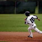 baseball player running on court