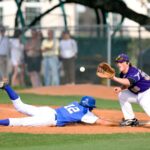 two man playing baseball during daytime